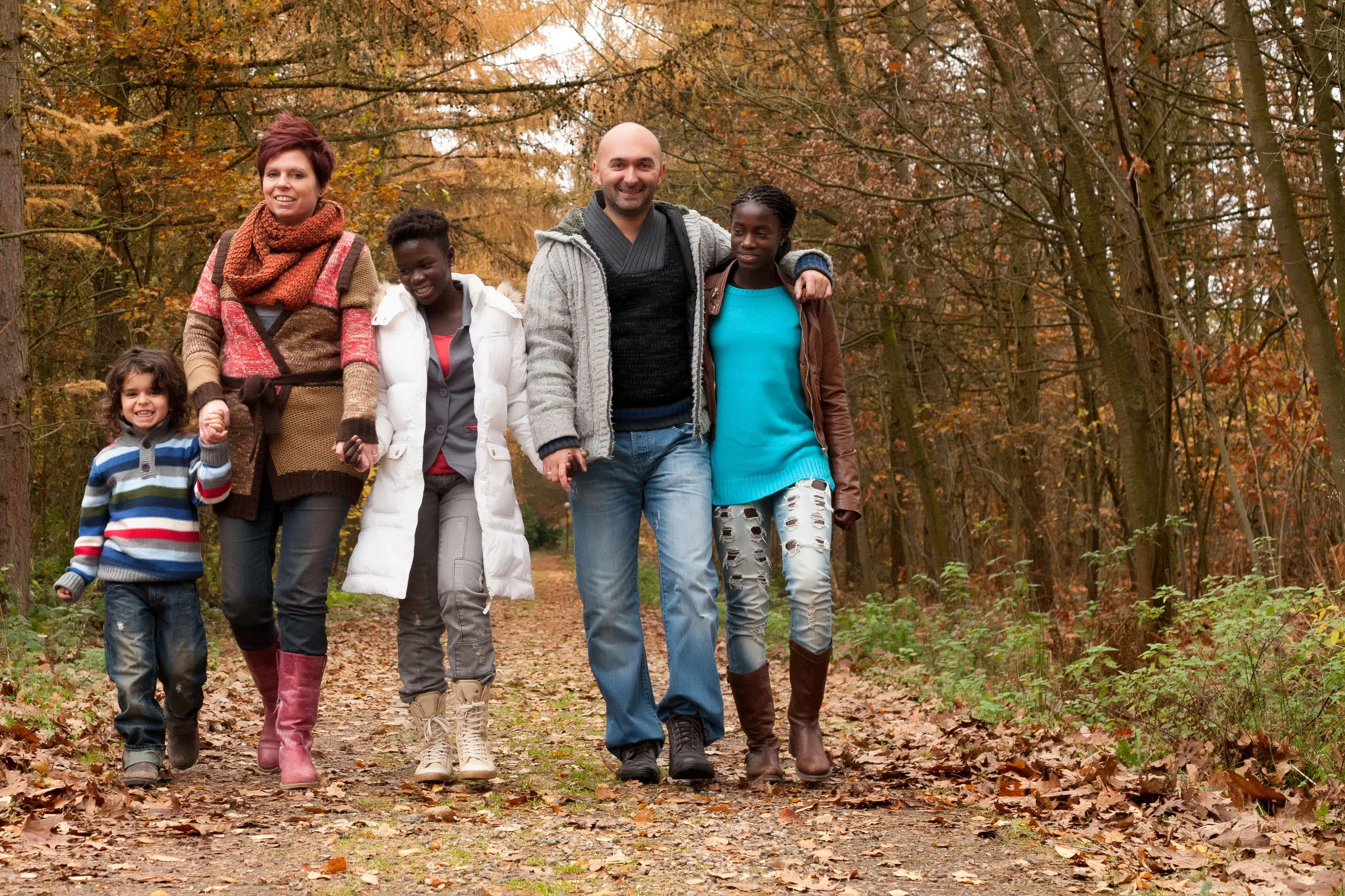 Foster Family Walking Through The Forest To Represent Foster Parents