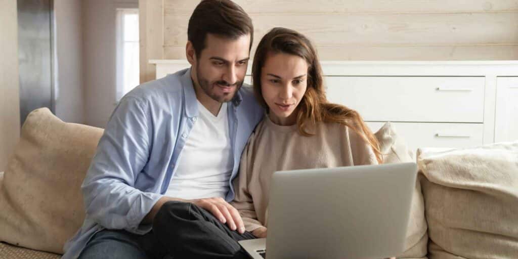 Couple at laptop asking the question are foster parents self-employed
