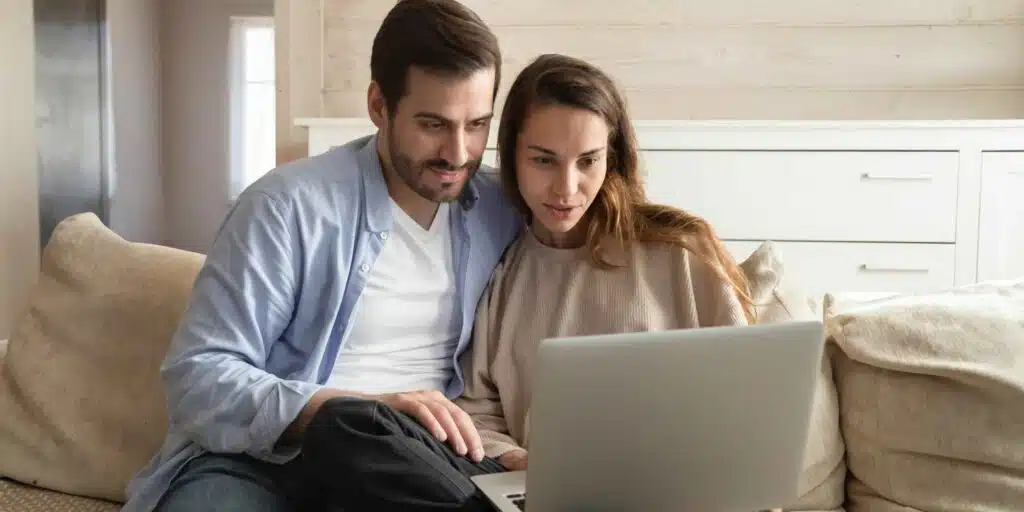 Couple at laptop asking the question are foster parents self-employed