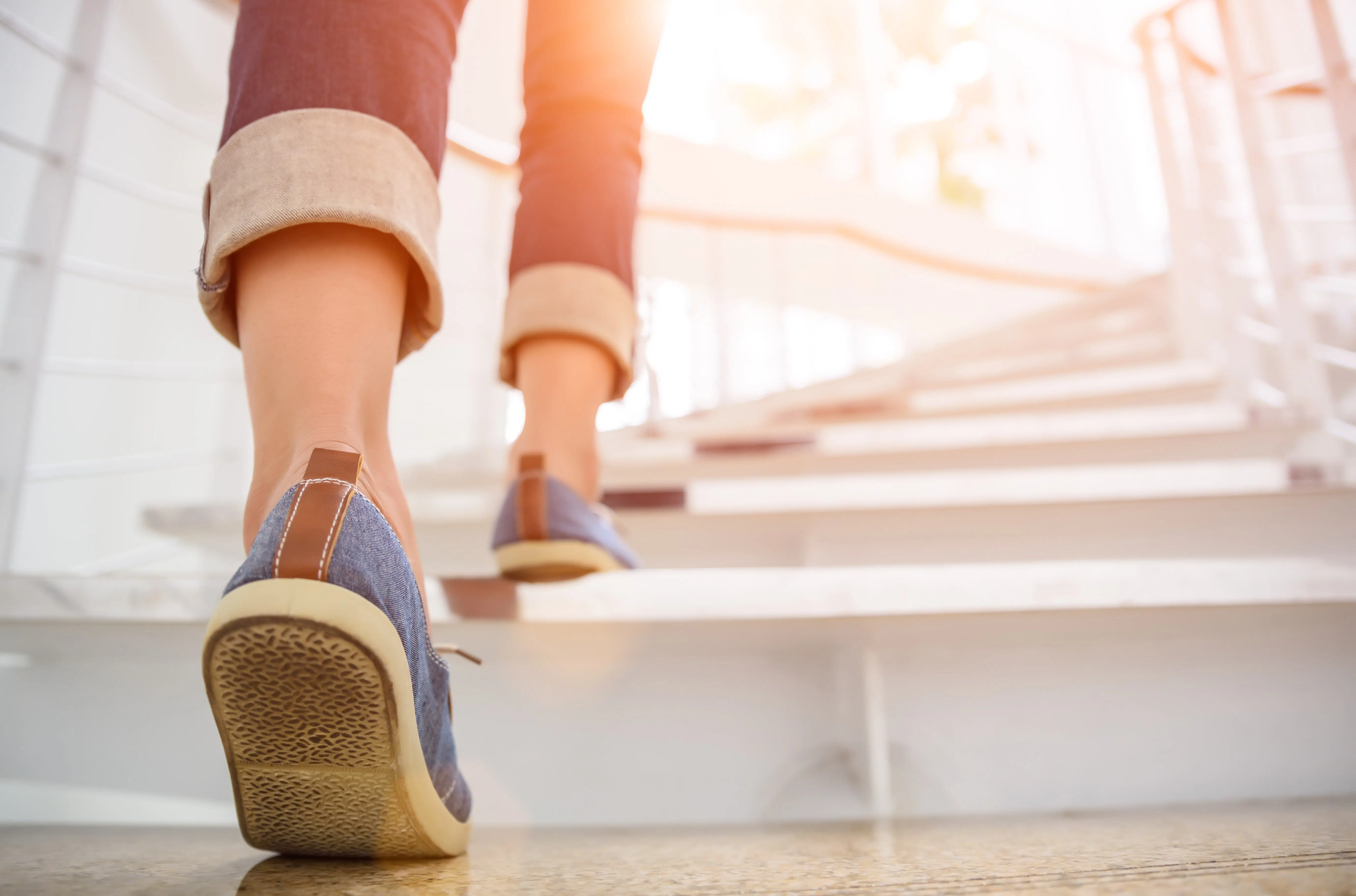 Someone walking up stairs to represent taking the first steps into fostering