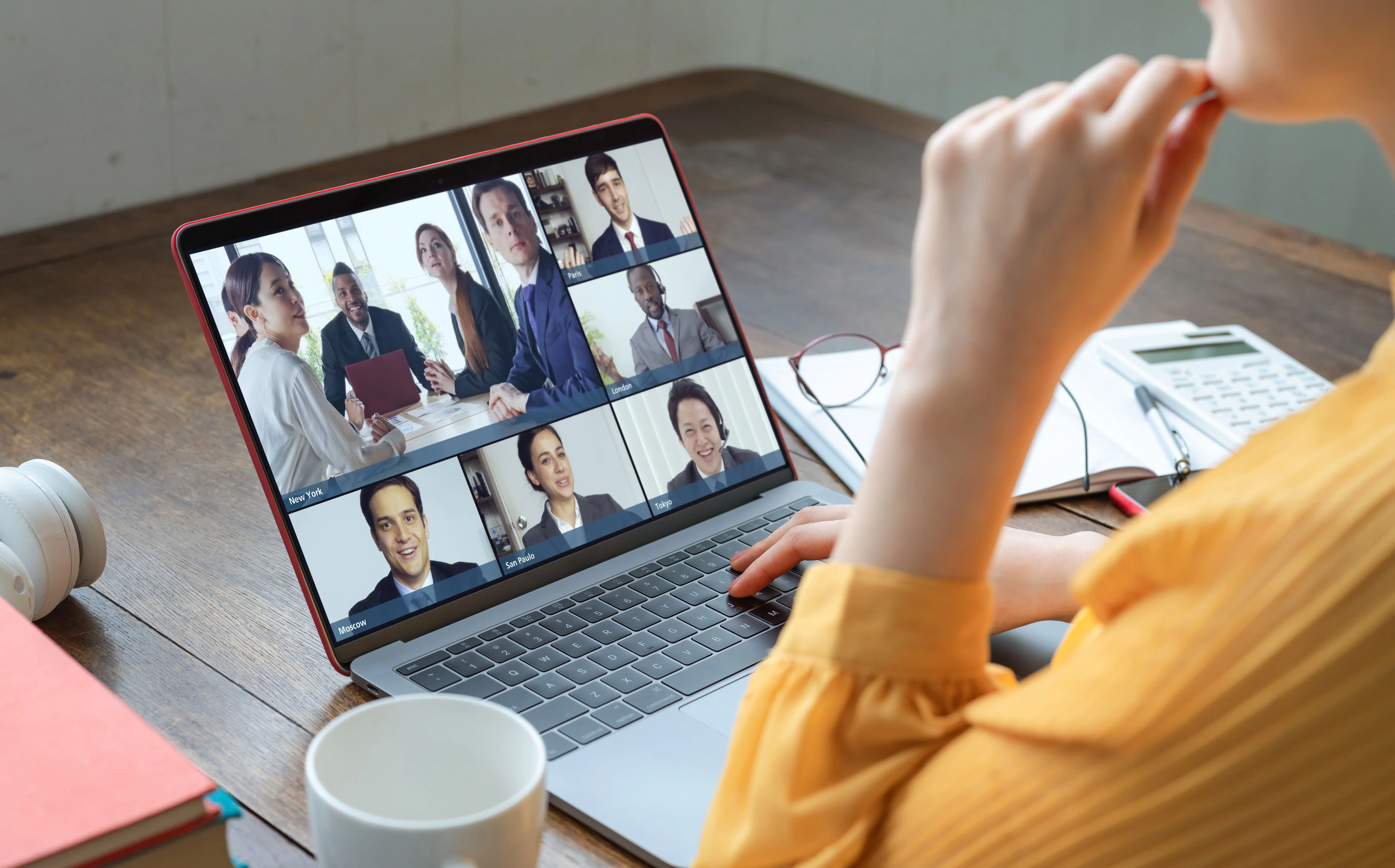 Woman on laptop with call on screen to represent technology in fostering