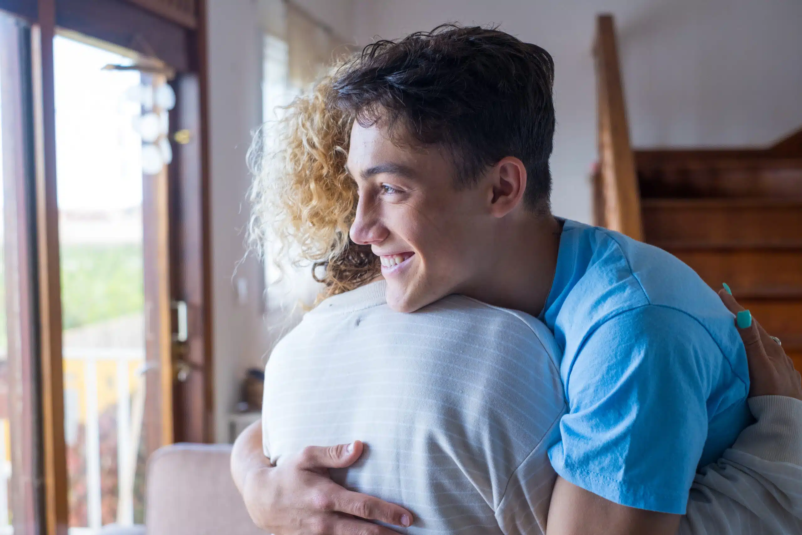 Young man hugging woman