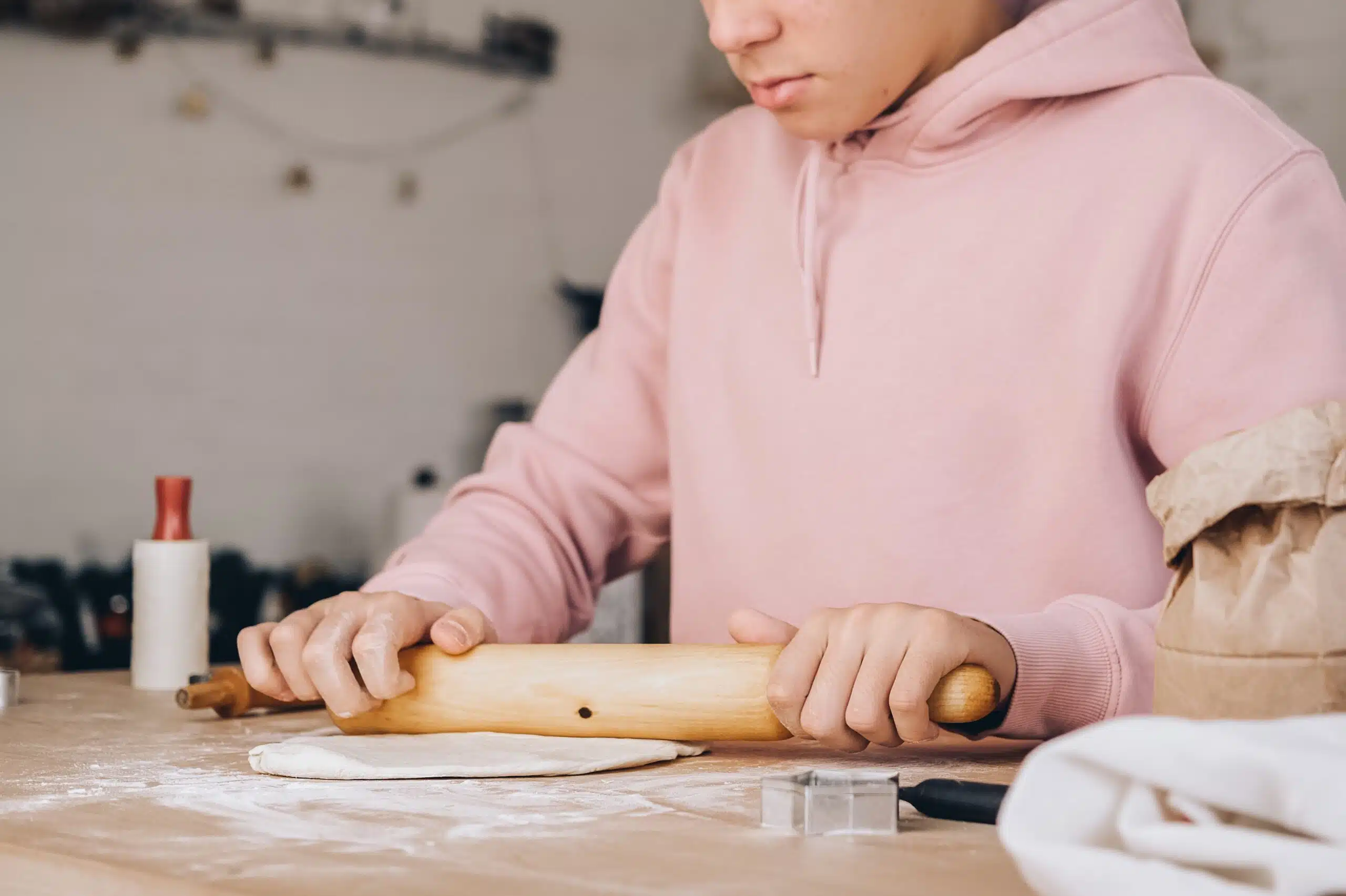 Teenage foster child making pizza